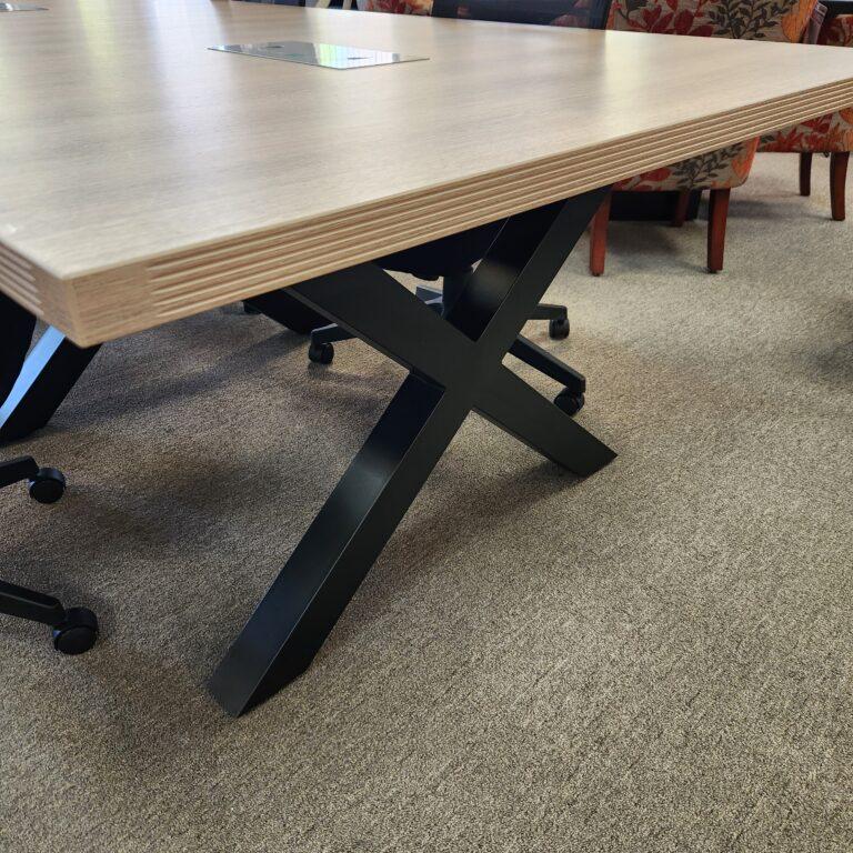 Edge and base detail for the Ryker conference table showing ribbed edge and X Base.