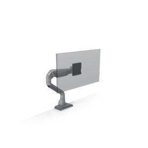A silver HAT Design Works E5 Single Dynamic Monitor Arm is shown in a studio shot, securely attached to a white surface via a top-down clamp mount. The arm is composed of two segments: a lower curved base segment and an upper dynamic segment that extends outward. At the end of the arm is a black VESA mount adapter, which is shown supporting a large, semi-transparent glass pane representing a monitor up to 49 inches. The sleek, industrial design features visible joints for height and tilt adjustments.