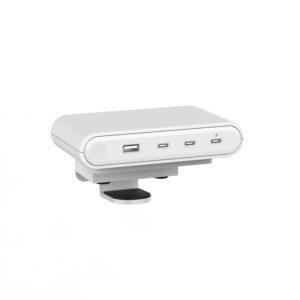 The Reya 140W Surface Power Module in white, featuring a ribbed texture on the top and sides. The front glossy panel displays four charging ports: one USB-A port on the left and three USB-C ports to the right. Below the main unit is a top-down clamp mount designed for securing the module to a desk edge.