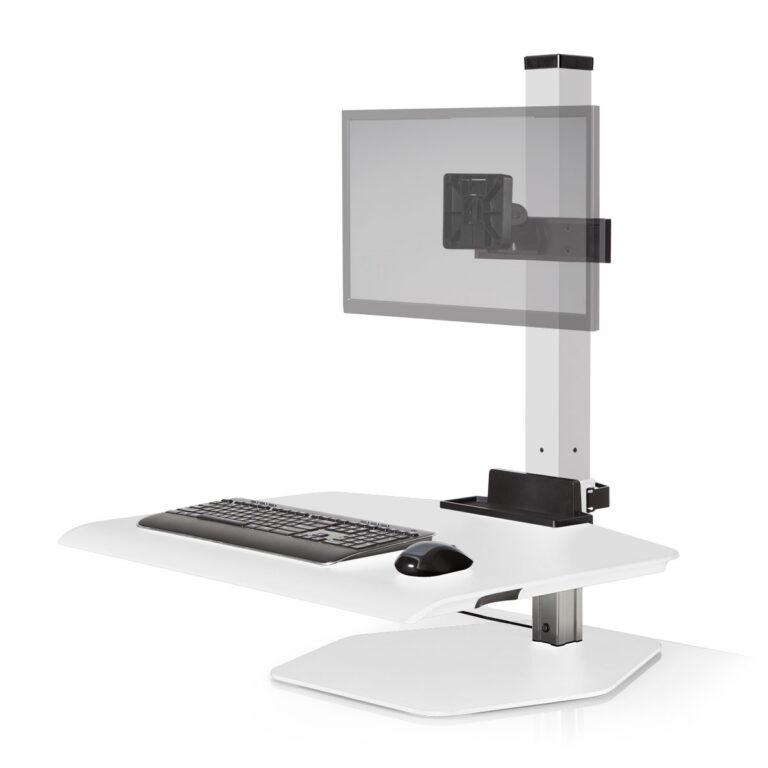 A Winston Workstation sit-stand converter is shown against a white background, featuring a large work surface with a keyboard and mouse. A central pillar supports an adjustable monitor mount with a semi-transparent panel representing a screen. The unit sits on a flat, hexagonal metal base and includes a small utility tray at the bottom of the support column.