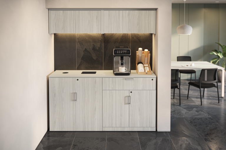 A recycling and trash storage cabinet with light wood laminate cabinets, integrated waste slots, and overhead storage in a breakroom setting featuring an espresso machine and a dark backsplash.