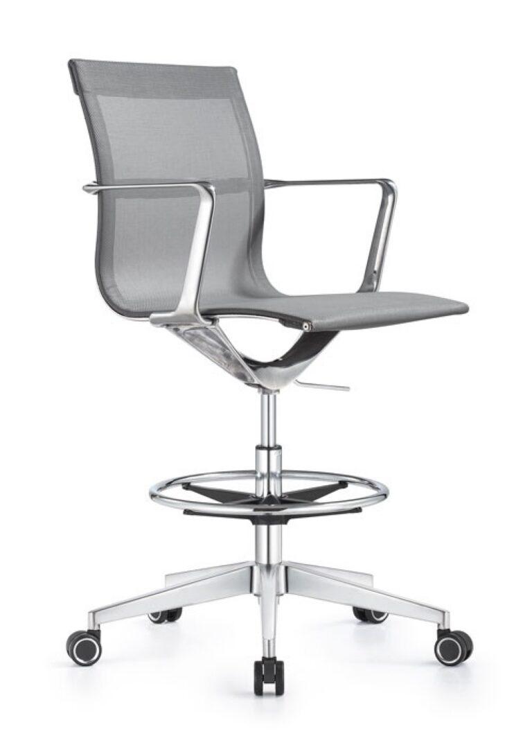 A Joan office stool featuring gray mesh upholstery, chrome armrests, a circular footrest, and a five-star chrome base with black and silver casters.