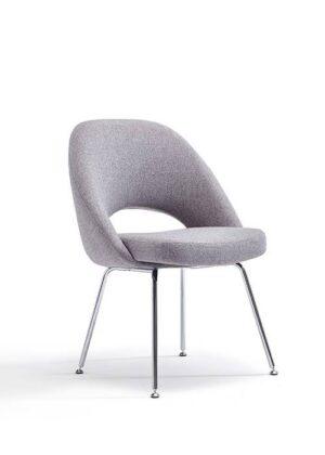 A Melanie armless guest chair featuring gray fabric upholstered padding with a curved backrest and a distinctive integrated teardrop cutout. The chair is supported by a slim chrome four-legged base with adjustable glides, designed for stability and a minimalist aesthetic.